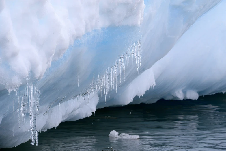 an image of the tip of an iceberg that is melting