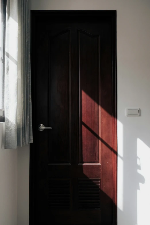 sun streaming through a window on top of a door