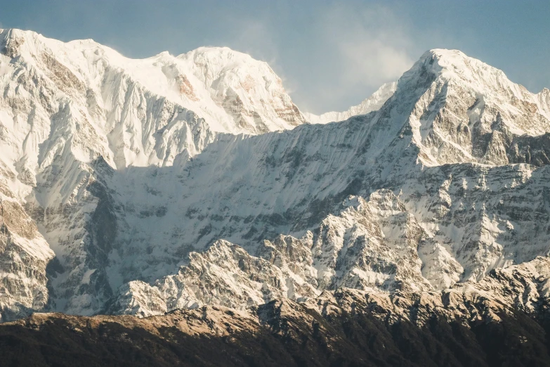 the snow covered mountains are rising high in the air