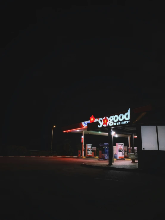the exterior of an american gas station at night