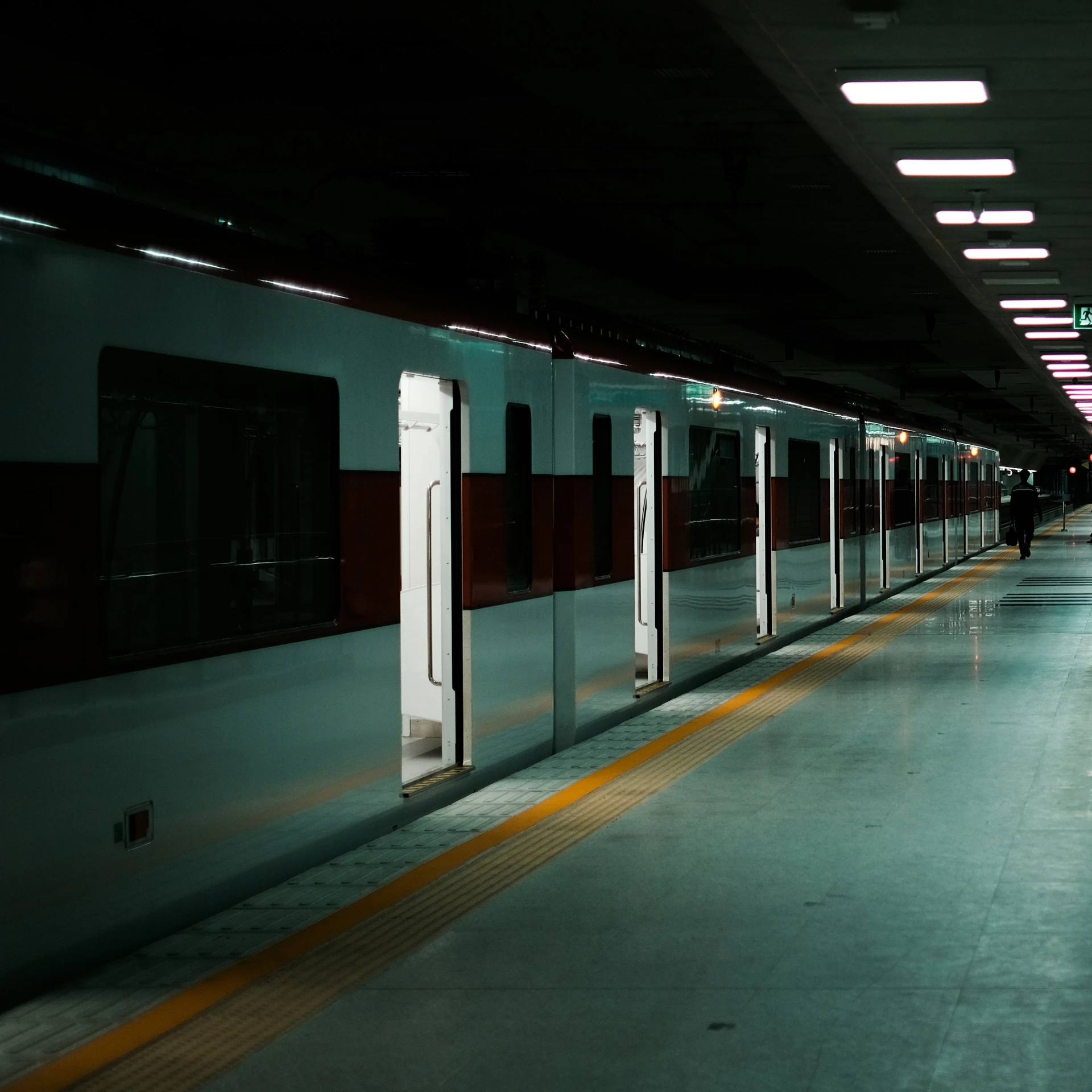 a train station with people waiting for their trains