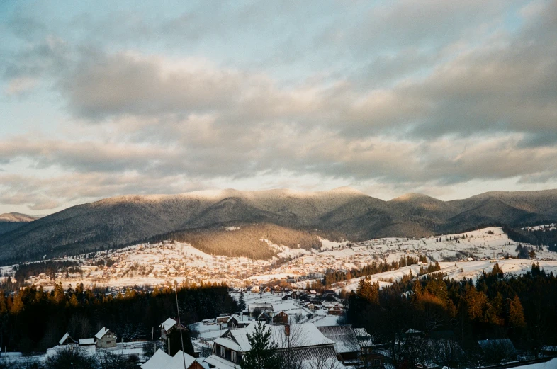 snow covered mountains with houses on them and buildings