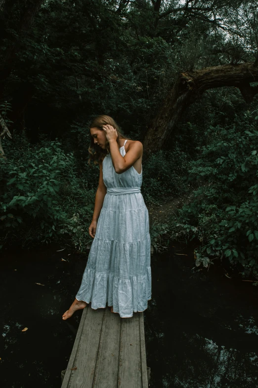 a woman on a dock in the woods