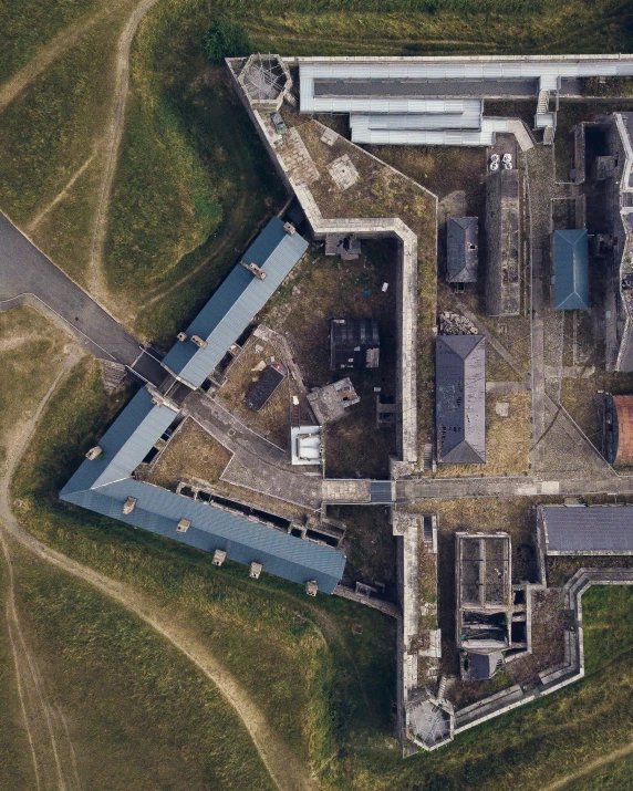 an aerial view of a structure and grassy area