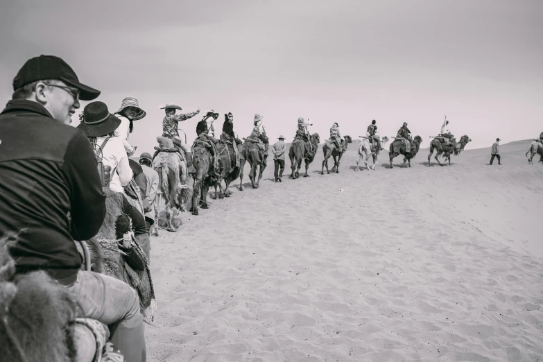 a group of people riding horses down a road