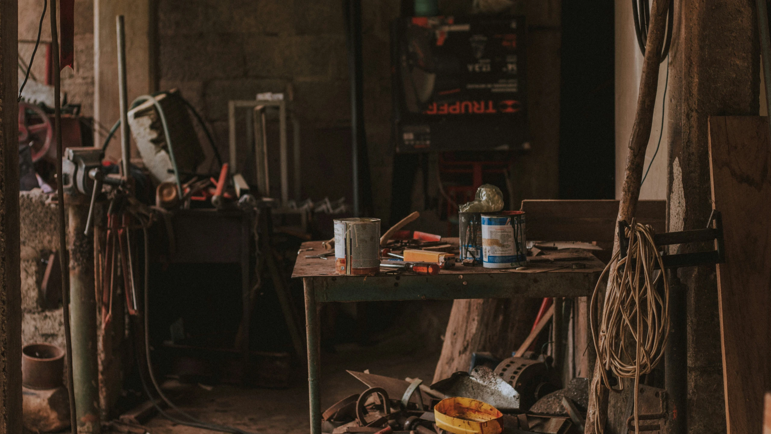 a work bench with two jars and cans on it