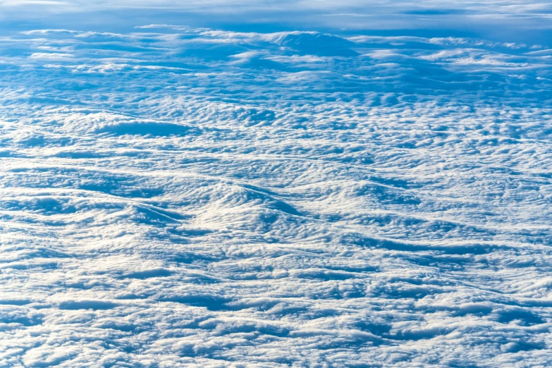 the view from above of a cloudy sky with footprints