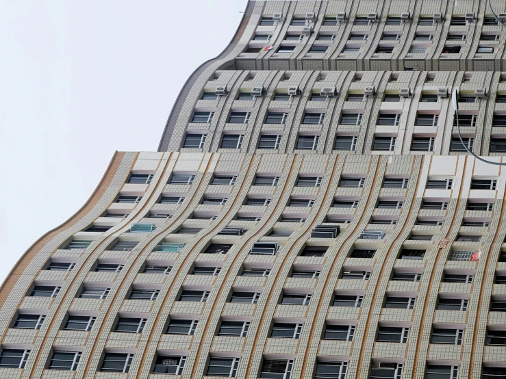 a very tall building with many windows next to another building