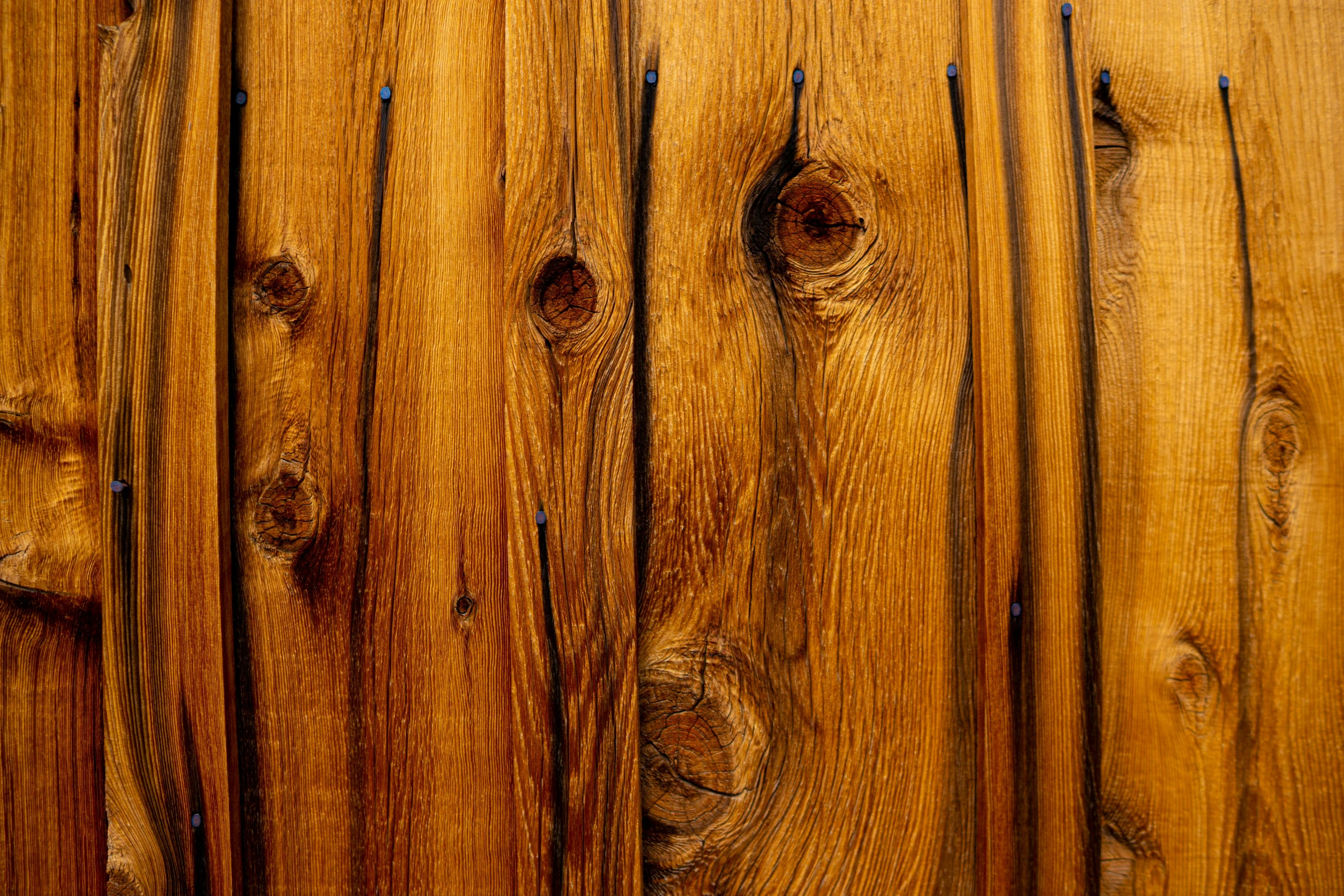 a close up of the top half of a wood paneled wall