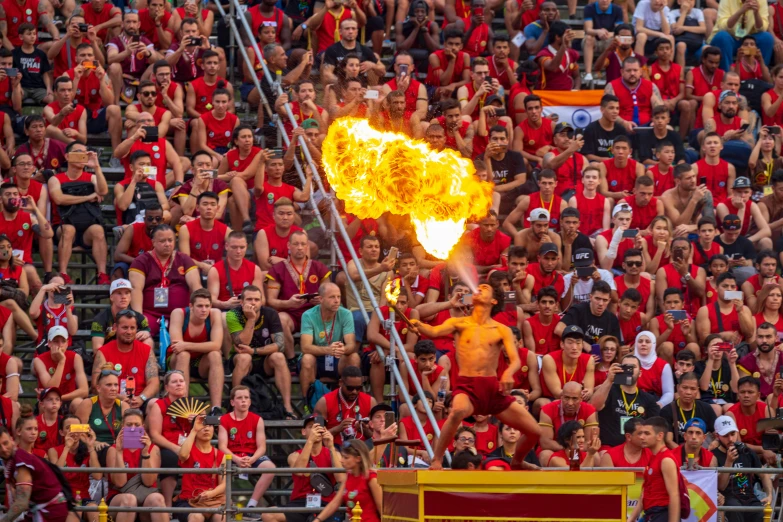 fire show in an open air arena surrounded by spectators