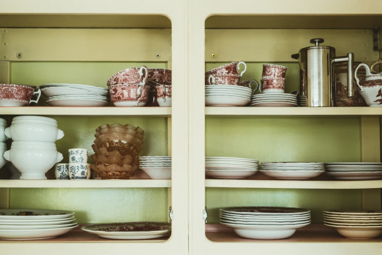 the shelves are filled with a variety of dishes