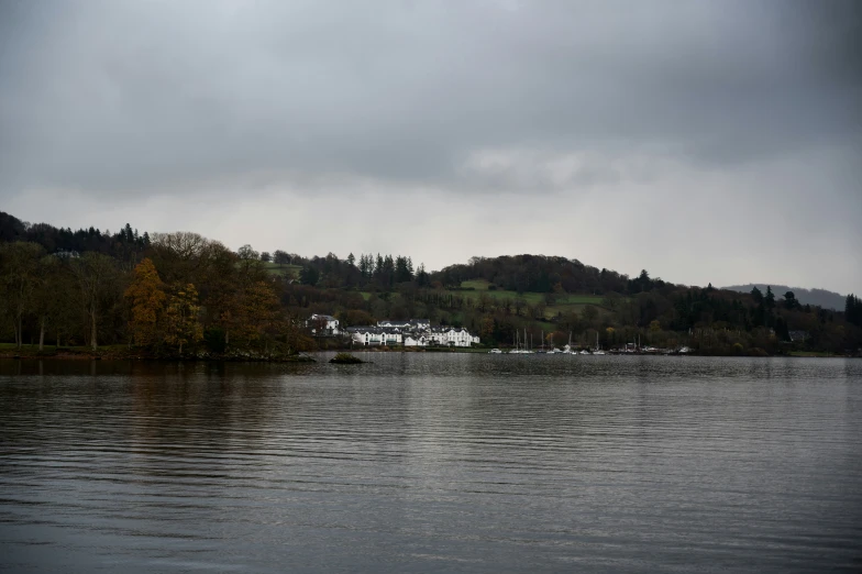 a body of water surrounded by trees and hills