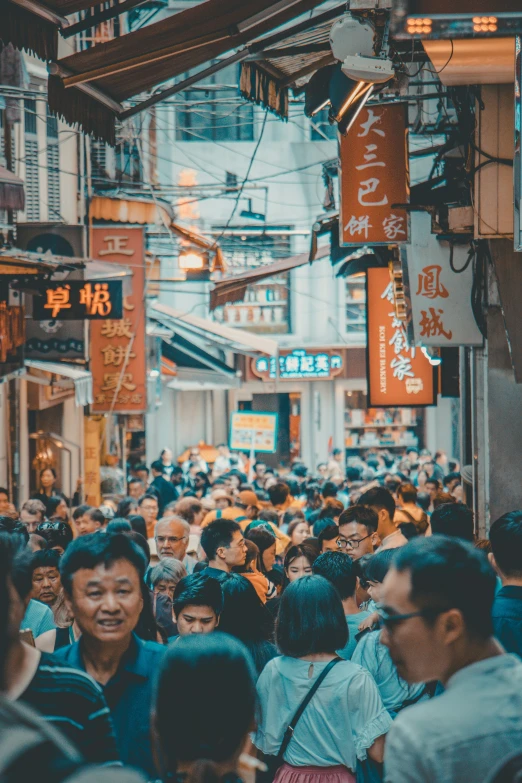 a group of people walking through a market area