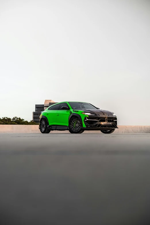 the porsche cayen is parked in front of a tall building