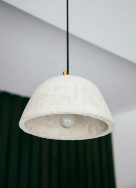 white hanging lamp hanging on a brown curtain