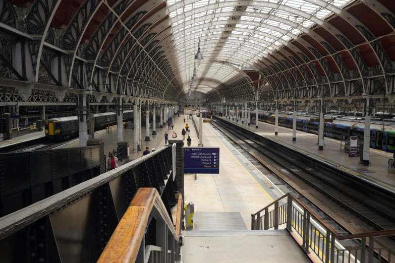 a train station with a platform that has trains on it