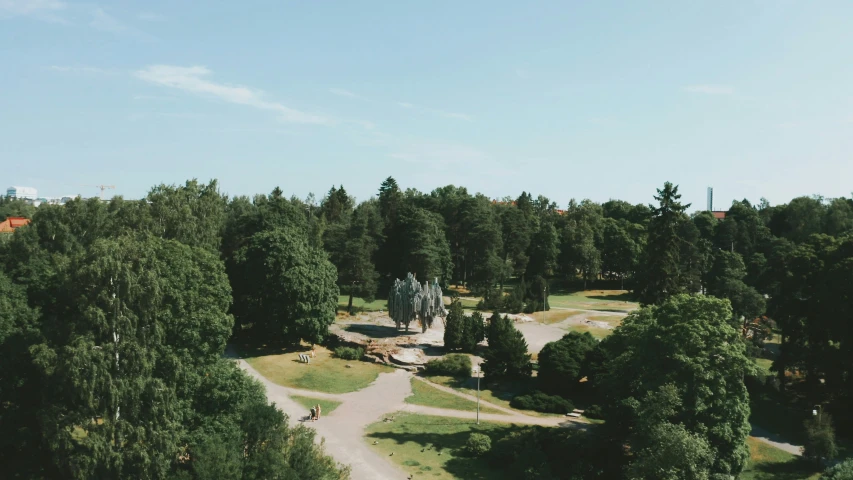 an aerial view of a park with trees and a road