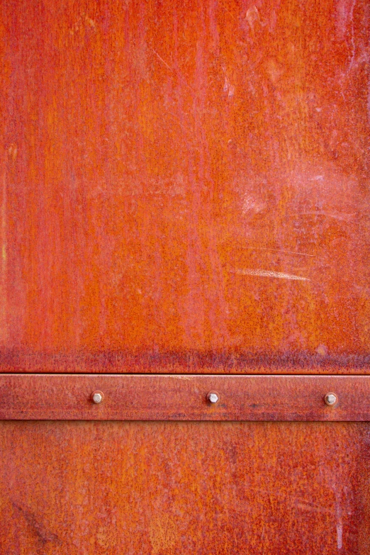 an orange piece of luggage sitting on top of a wooden floor