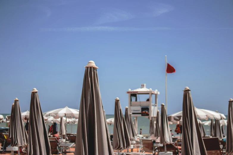 many umbrellas that are near the beach with one in it