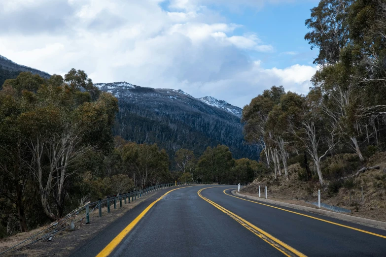 a road with the mountains in the background