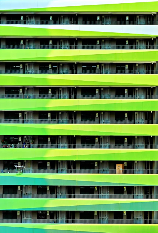 a tall green building sitting in the middle of an airport