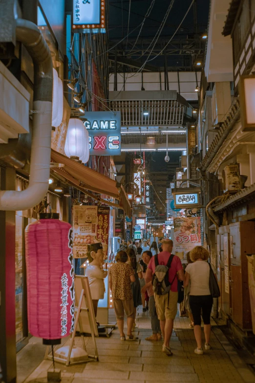 people walk along a crowded street in a foreign city