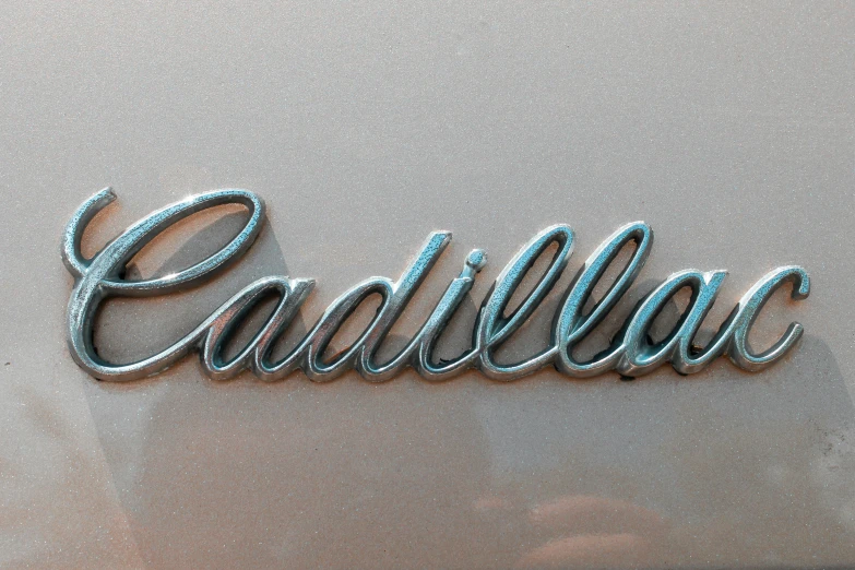 chrome letters on an old car advertising cadillac