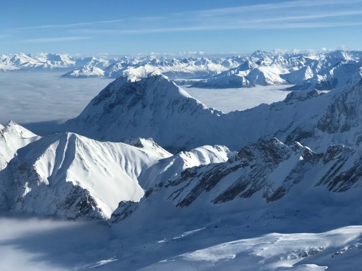 the view from the top of a mountain shows snow - capped peaks