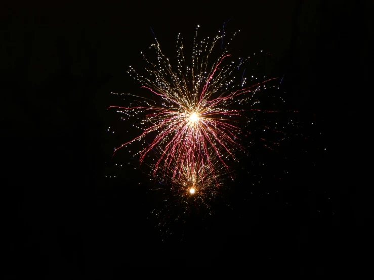 firework exploding in the night sky with it's lights on