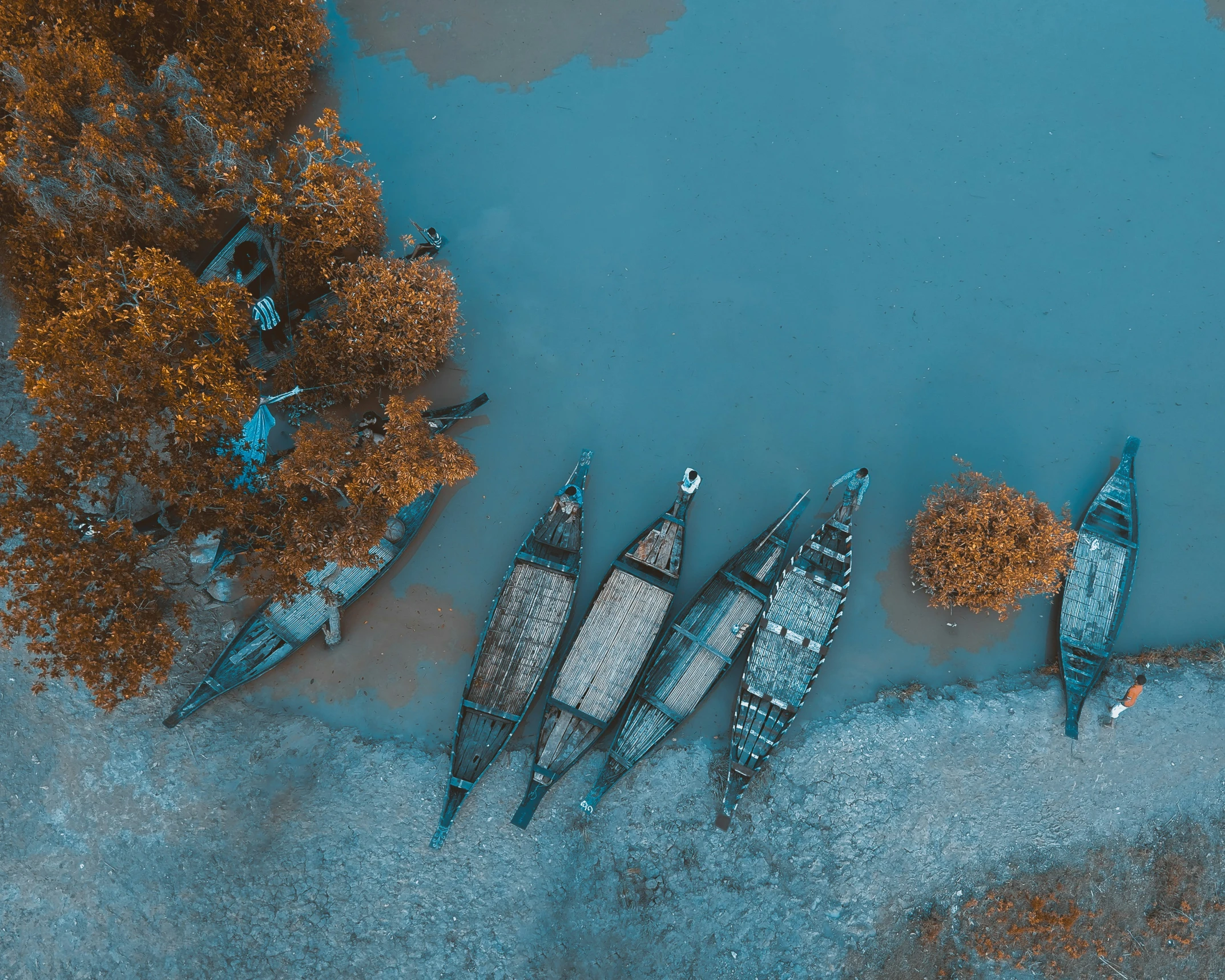 an aerial view of several canoes floating on a lake