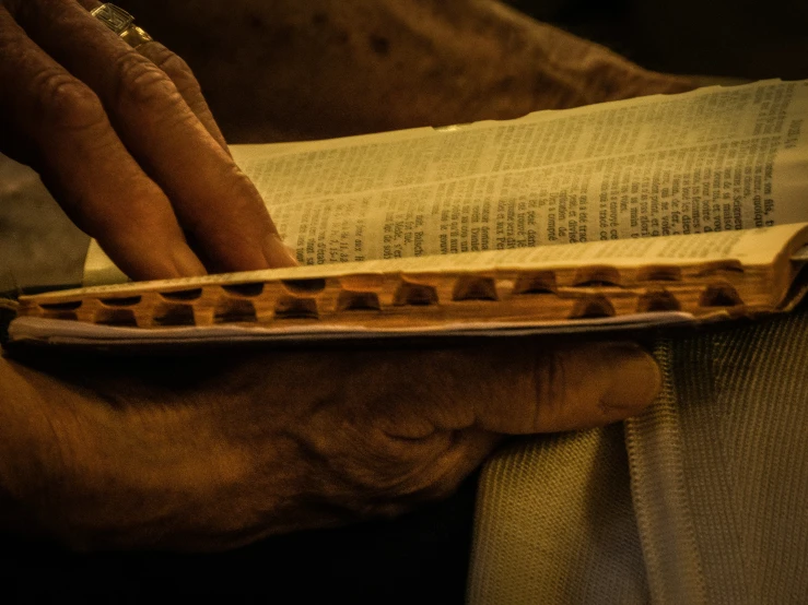 someone holding an object made out of pieces of paper