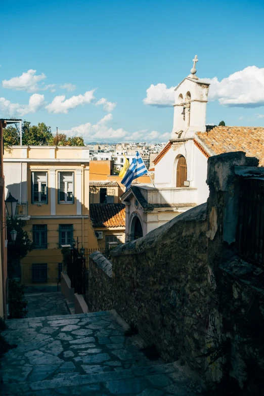 a steeple with the view of some buildings below