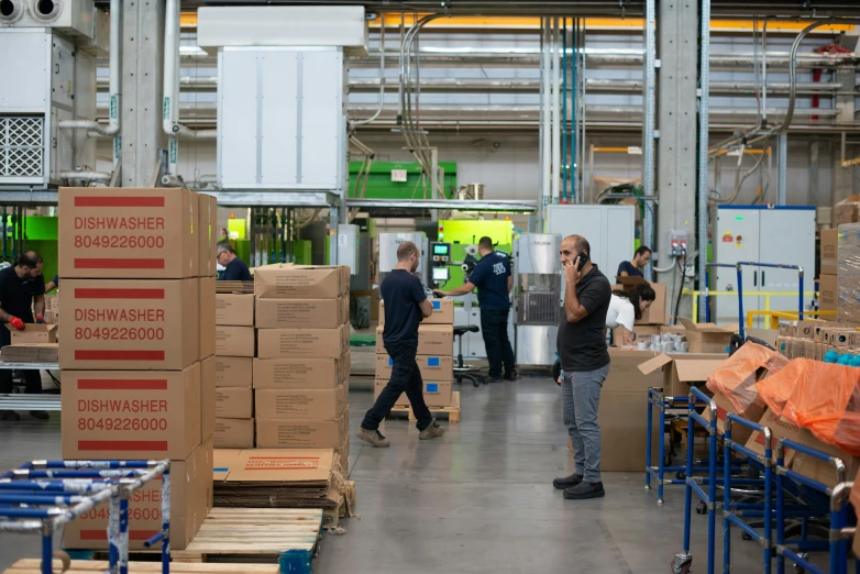 several men standing in a warehouse near boxes