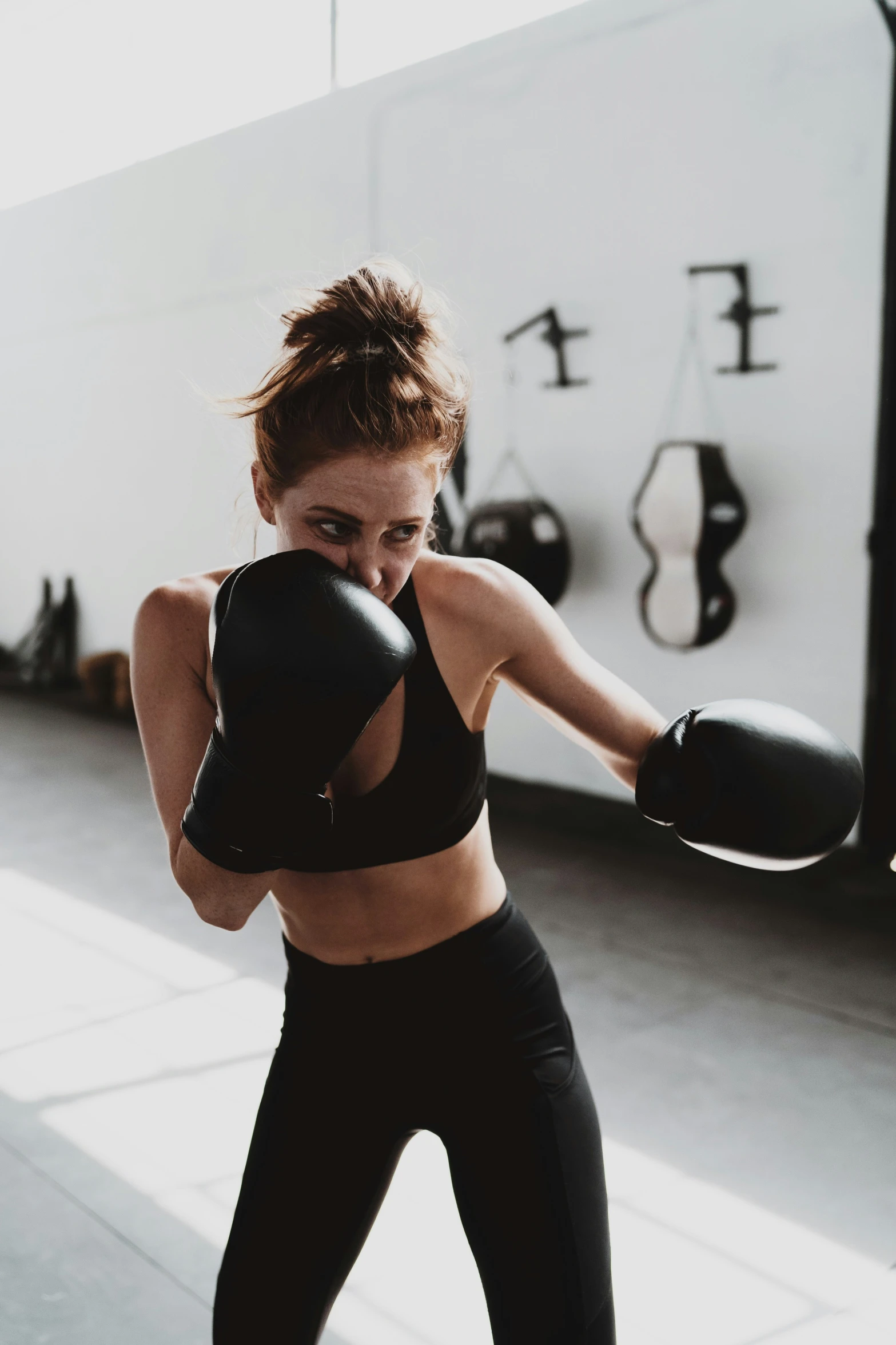 a girl practicing boxing in a gym