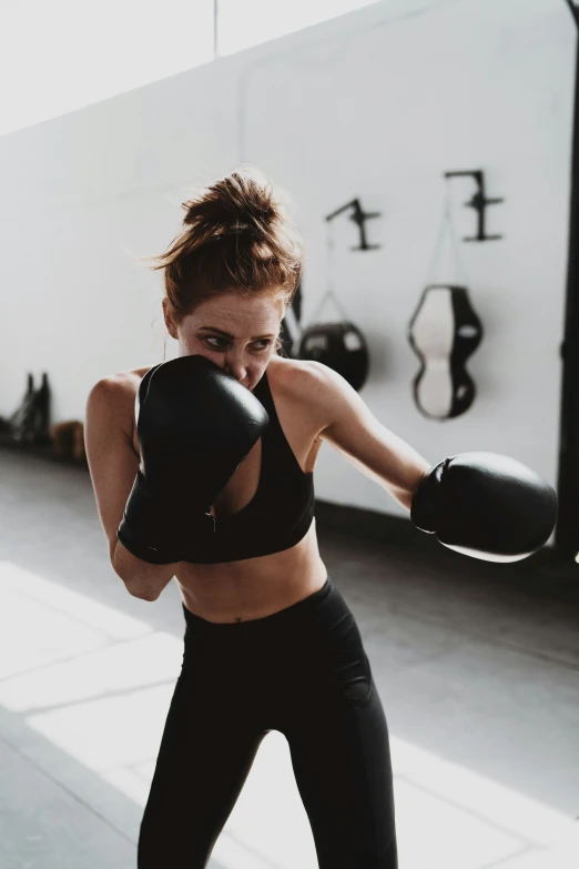 a girl practicing boxing in a gym