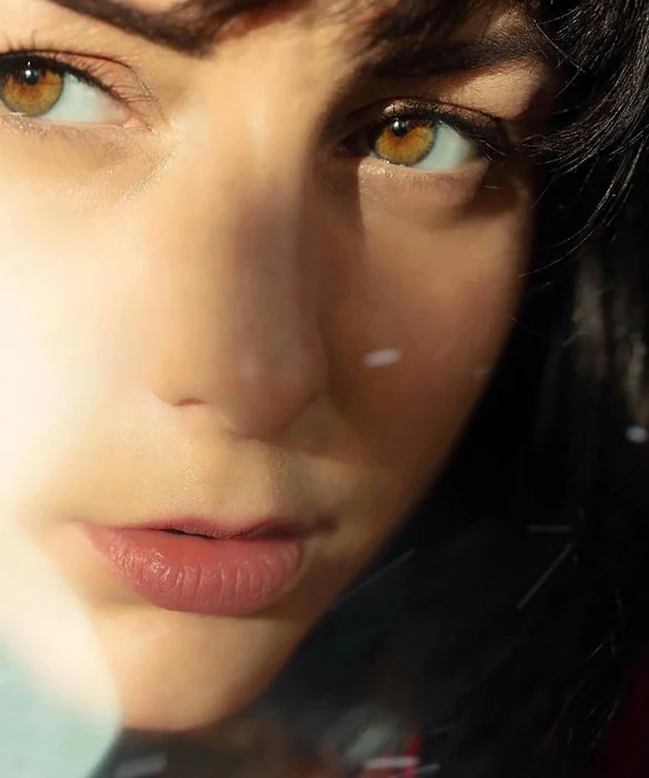 close up of woman's face on snowy surface