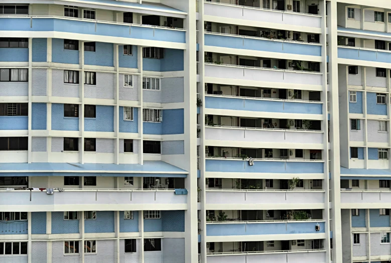 a tall building with multiple windows and a street light