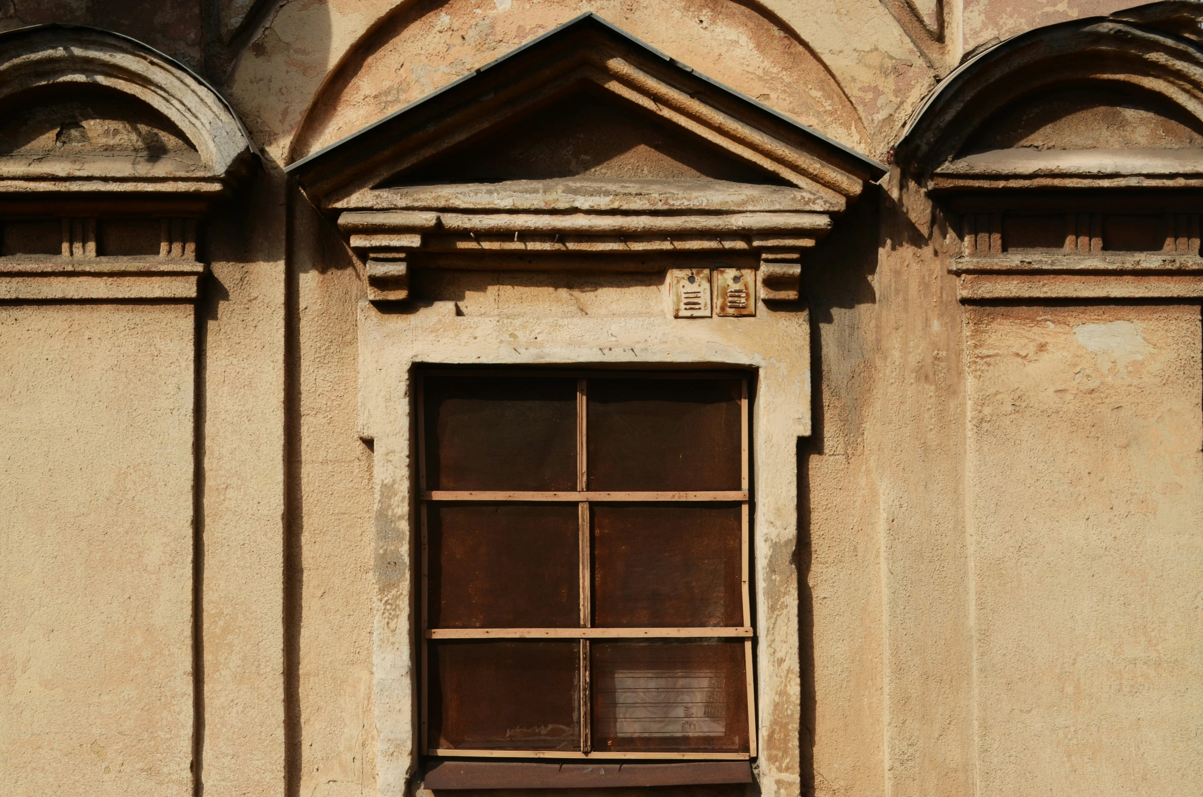 a window with bars and the name in latin script