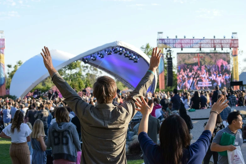 a crowd of people standing around and watching an event