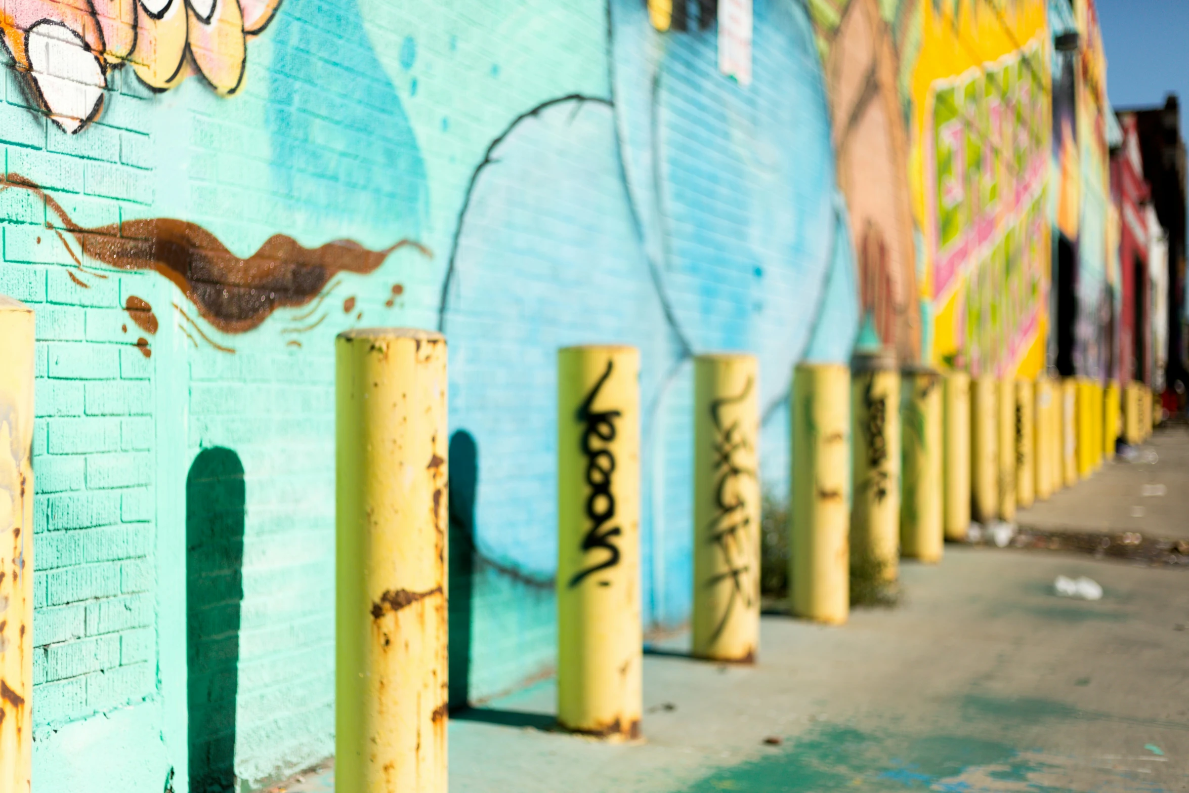 a bunch of yellow posts that are in front of a building