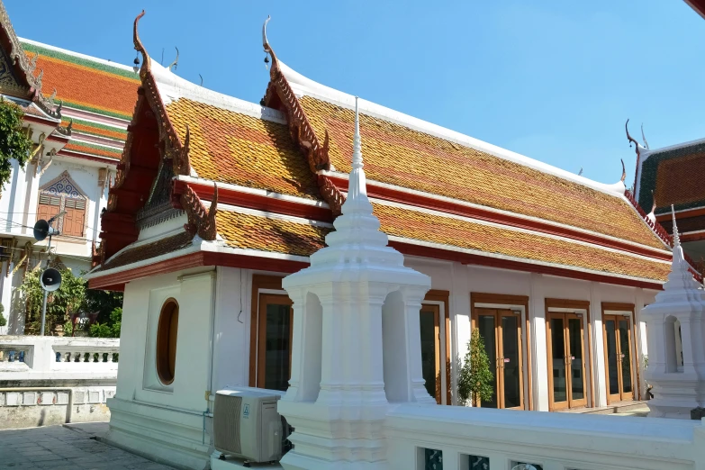 an ornate white building in a thai park