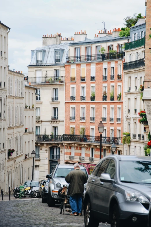 a couple of people walking next to a row of buildings