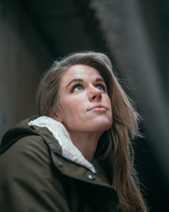 a woman is looking up to the sky