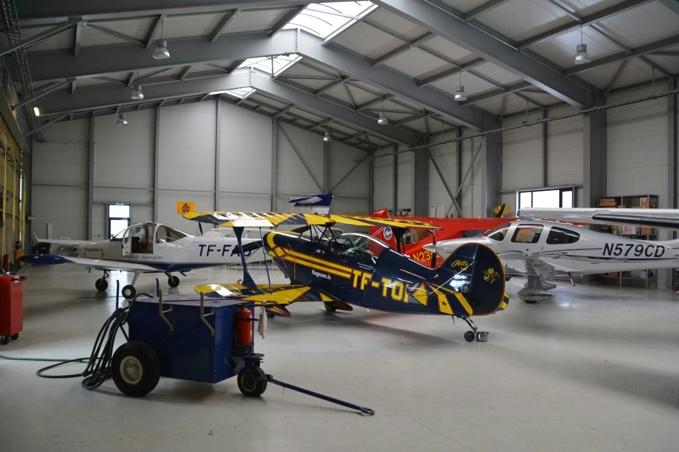 a hangar with small airplanes inside of it