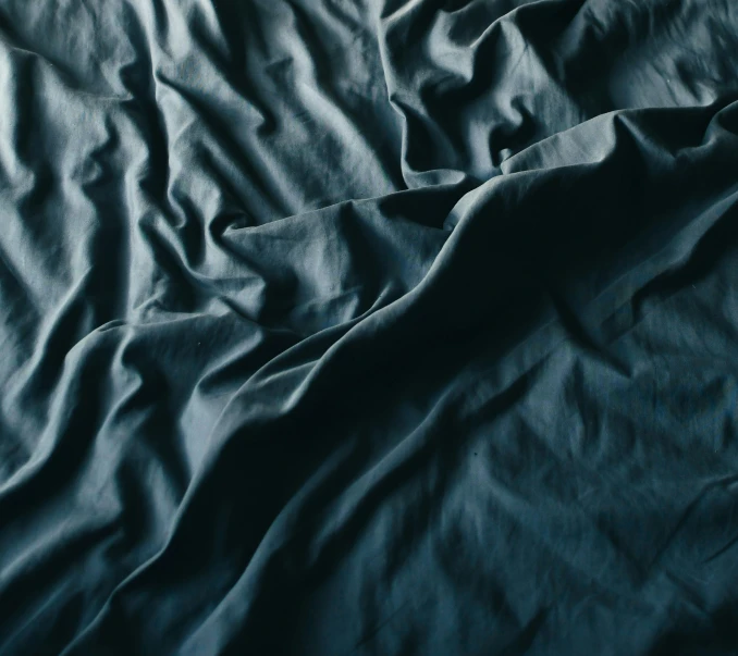 the blanket with wrinkled edges is dark blue