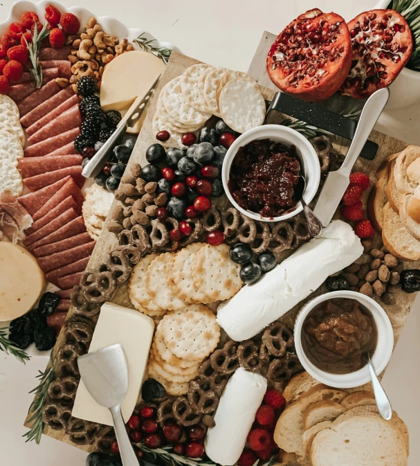 a platter has ers, cheeses, and other food items on it