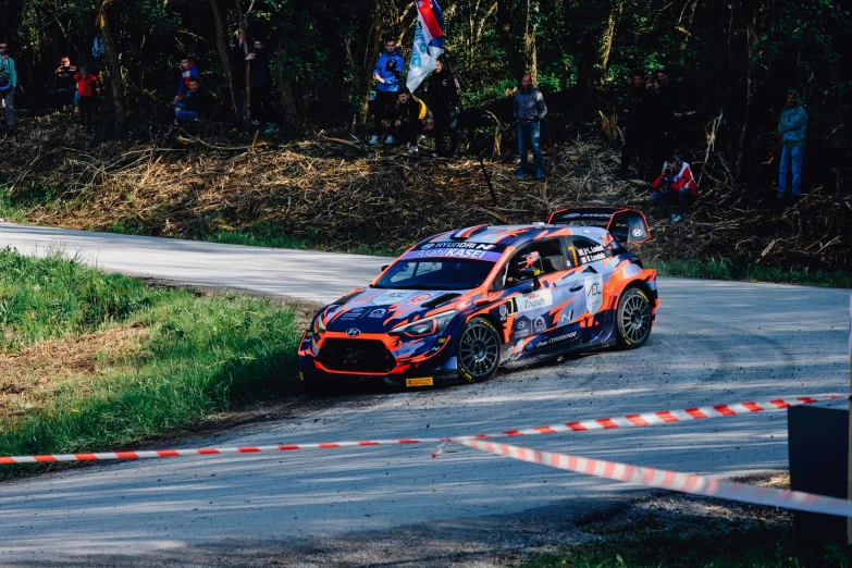 a car making a sharp turn with it's hood pulled back in a tight circle