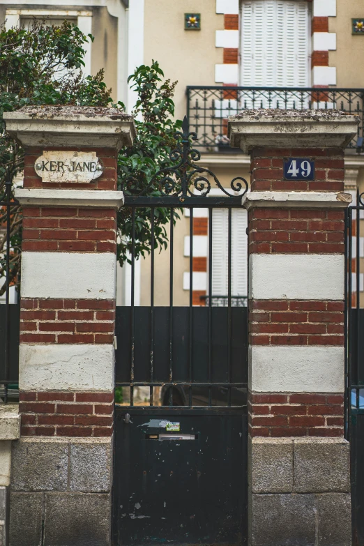 an entrance to a building with wrought iron gate