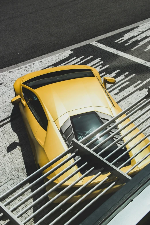 a yellow sports car parked near a curb