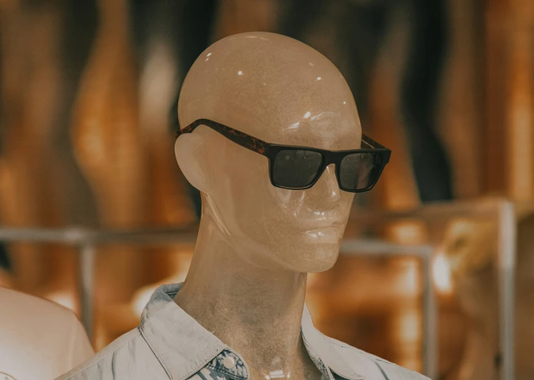 a po of a bald head wearing sunglasses